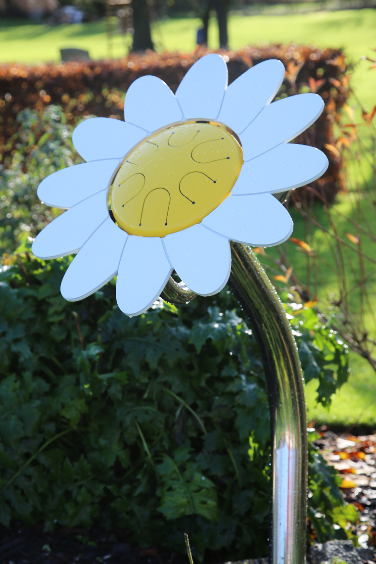 an outdoor musical drum in the shape and colours of a daisy