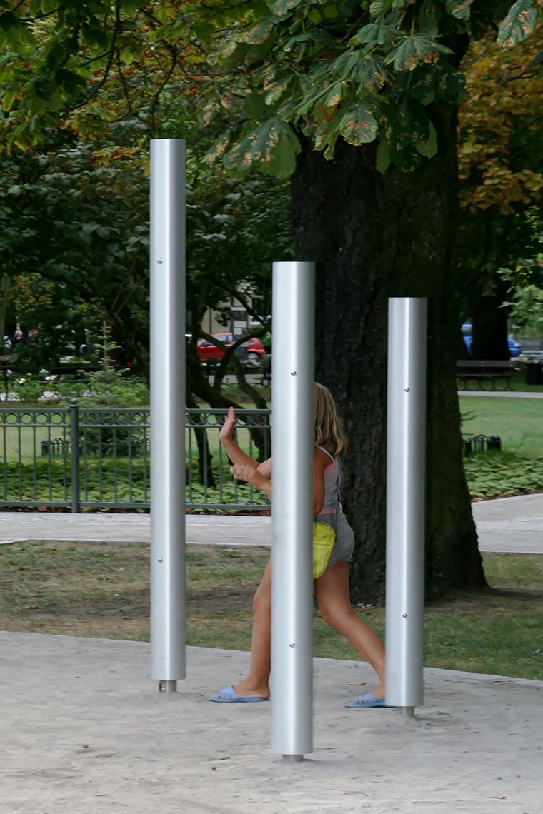 Three silver chimes installed in a children's playground