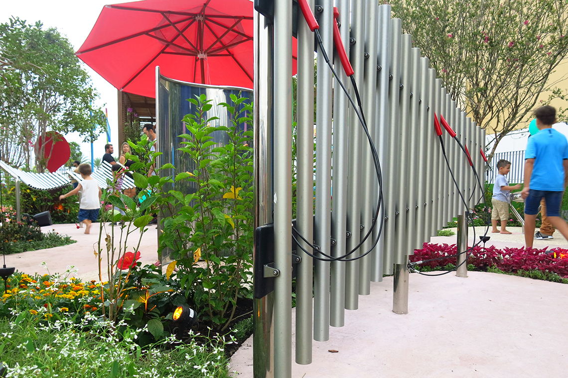 a set of large outdoor musical silver chimes in a musical park or playground 